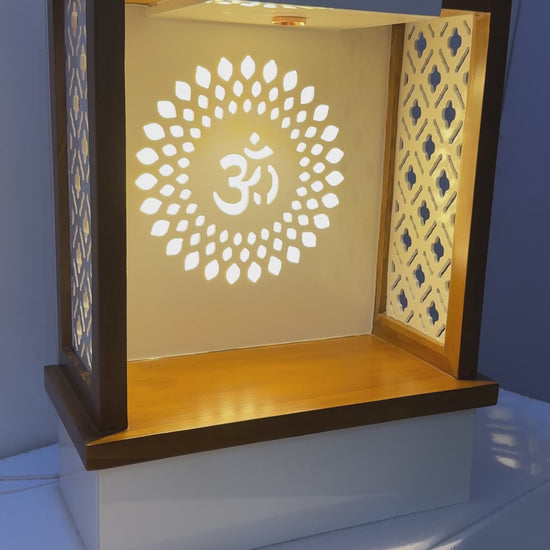 Sleek pooja unit combining contemporary aesthetics with traditional elements like patterned panels and warm LED lighting.